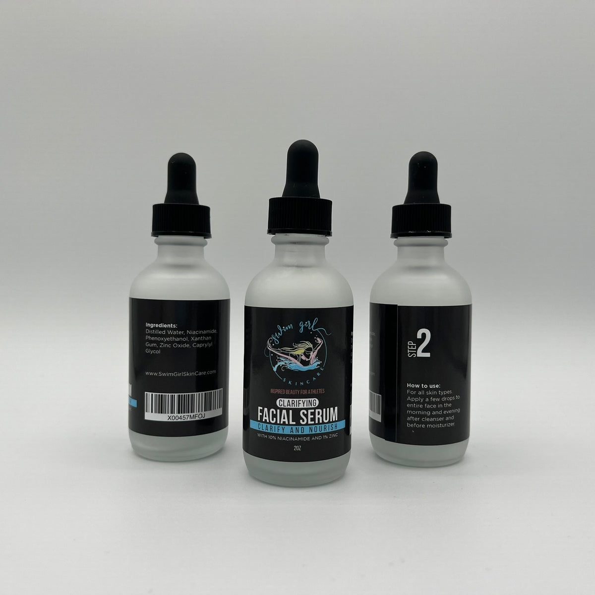 Clarifying Facial Serum dropper bottles shown from the back, front, and side